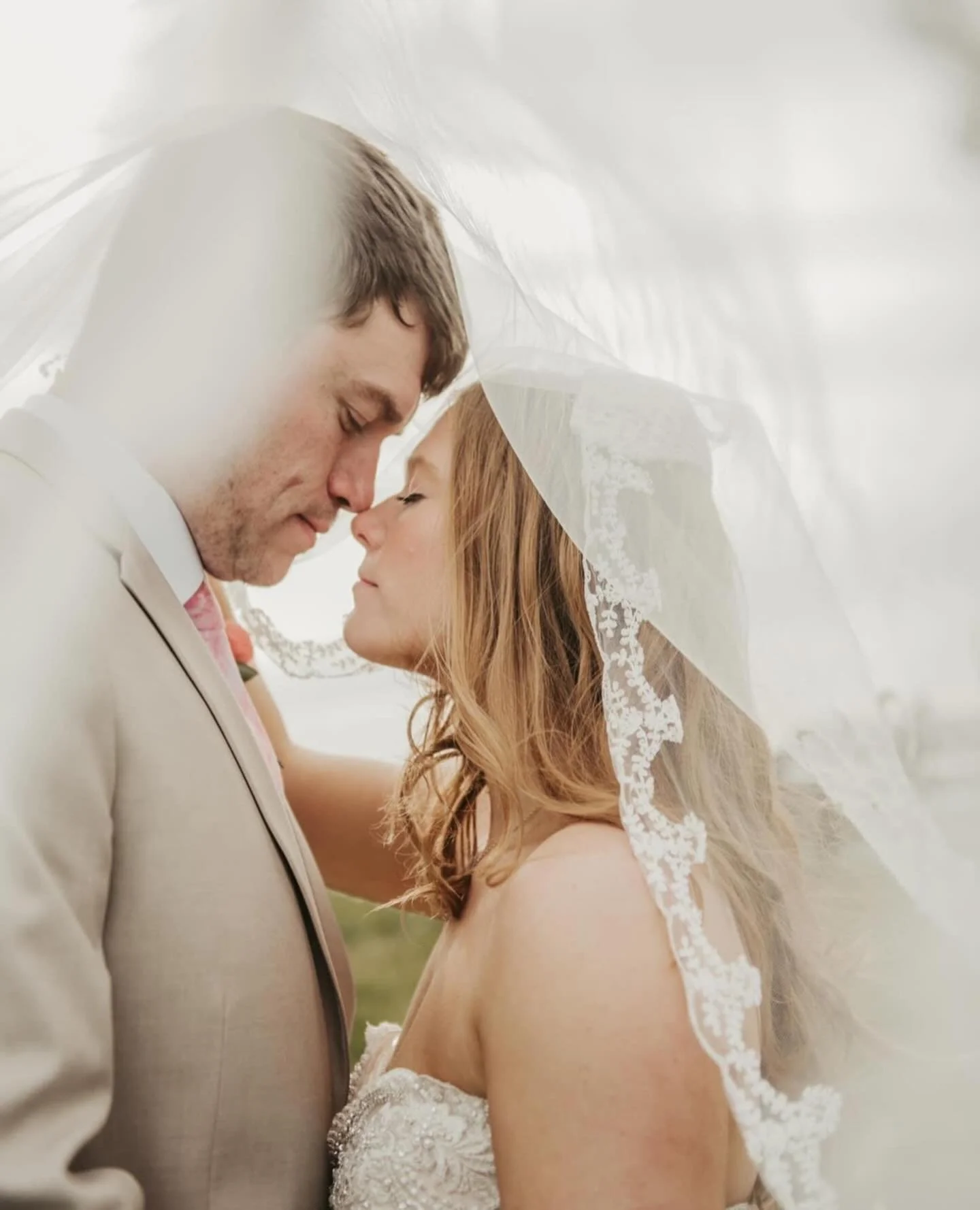 Bride and groom sharing a quiet moment under the veil
